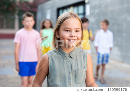 Cheerful girl walks along city street on day 120599176