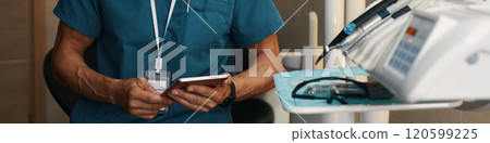 Holding Smartphone in Hospital Room Near Medical Equipment 120599225