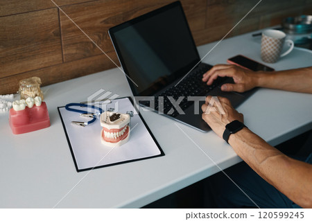 Working On Laptop Near Dental Tools in Dental Clinic 120599245
