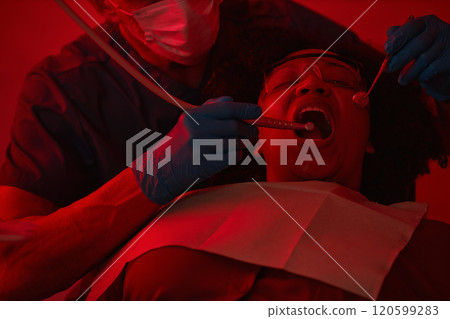 Dentist Examining Patient's Mouth Using Specialized Tools Dentist Examining Patient's Mouth Using Specialized Tools 120599283
