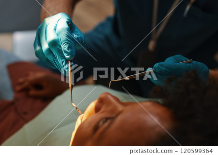 Inspecting Patient Mouth with Dental Instruments 120599364