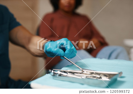 Doctor Preparing Surgical Instruments in Clinic Room 120599372