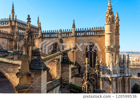 View from the Giralda Tower out over the roof and spires of the Seville cathedral with the city in view in Seville, Spain 120599536