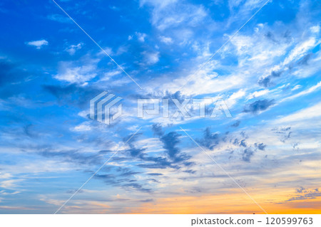 Scattered clouds in a vivid blue sky at dusk Background material 120599763