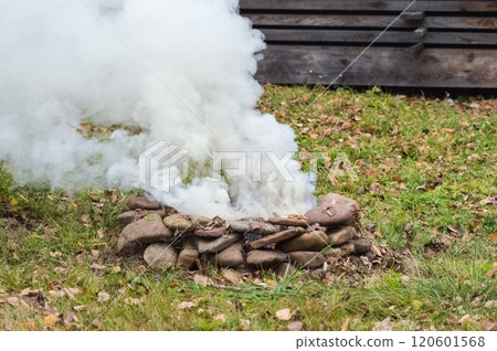Smoke from a stone fireplace in the forest, close-up Smoke from a stone fireplace in the forest, close-up 120601568