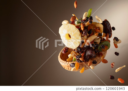 Dried tropical fruits with various nuts and raisins in motion. Dried tropical fruits with various nuts and raisins in motion. 120601943