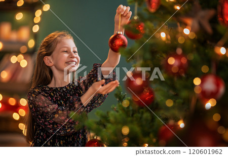 Child near Christmas tree indoors Child near Christmas tree indoors 120601962