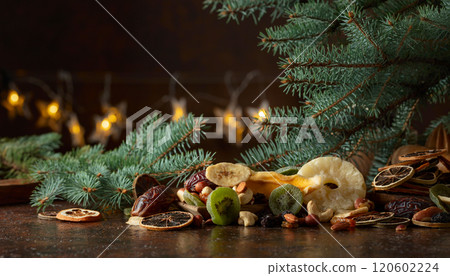 Dried tropical fruits with various nuts and raisins on a old brown table. 120602224
