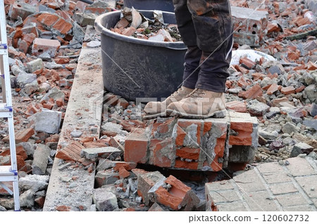 Worker Standing on Bricks at Construction Site 120602732