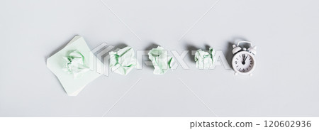 Burnout breaks concept. Crumpled note papers and alarm clock top view web banner 120602936