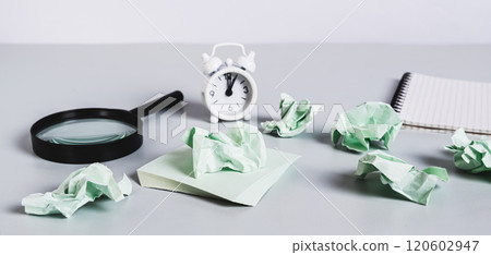 Crumpled note papers on a desk among office supplies, concept of burnout at work web banner Crumpled note papers on a desk among office supplies, concept of burnout at work web banner 120602947