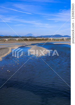 At Horai Bridge, the world's longest wooden bridge over the Oi River in Shimada City, Shizuoka Prefecture, the river reflects the color of the sky and Mount Fuji in the distance, vertical composition At Horai Bridge, the world's longest wooden bridge over the Oi River in Shimada City, Shizuoka Prefecture, the river reflects the color of the sky and Mount Fuji in the distance, vertical composition 120603683