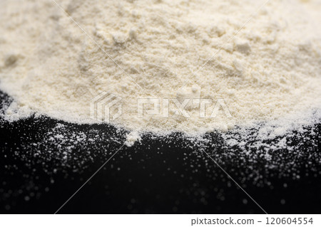 Close-up of protein powder on a black background Close-up of protein powder on a black background 120604554