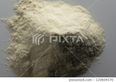 Aerial view of a pile of protein powder on a dark background 120604570