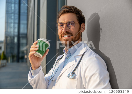 Ginger young doctor having morning coffee after a night shift 120605349