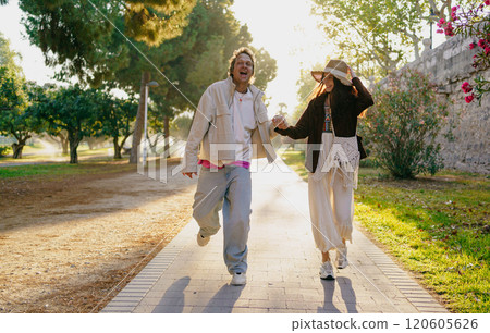 A Joyful Couple Happily Walking Together in Nature While Enjoying the Warm Sunshine 120605626