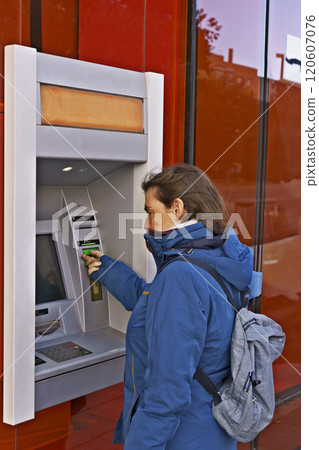 A woman is using a card reader to pay for something A woman is using a card reader to pay for something 120607076