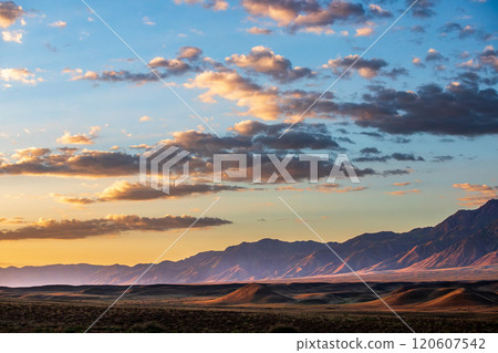 Breathtaking steppe morning landscape with a majestic Tian-Shan mountain backdrop, National nature park of Kazakhstan. 120607542