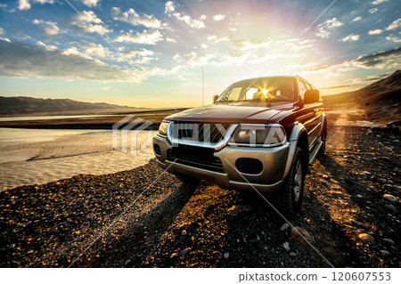 Prepared off road car on mountain trail near a wild lake on sunrise. Traveling by auto, adventure in wildlife, expedition or extreme travel on 4x4 automobile. 120607553