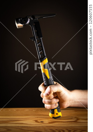 A solid and durable hammer, securely gripped, ideal for both DIY enthusiasts and professional contractors alike 120607555