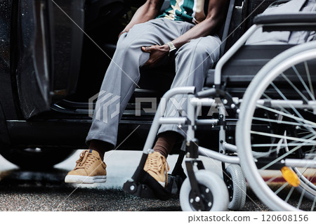 Low section shot of unrecognizable man with disability getting into car and using accessible vehicle features, copy space 120608156