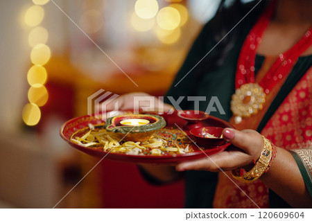 Holding Traditional Indian Diya Illuminating the Festival Holding Traditional Indian Diya Illuminating the Festival 120609604