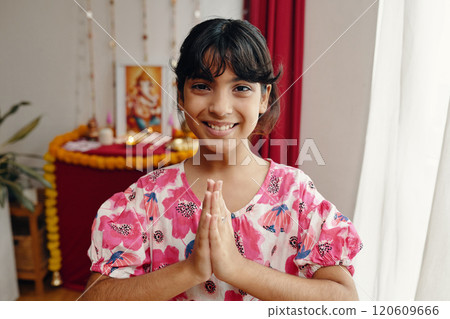 Smiling Girl with Hands in Namaste Gesture 120609666