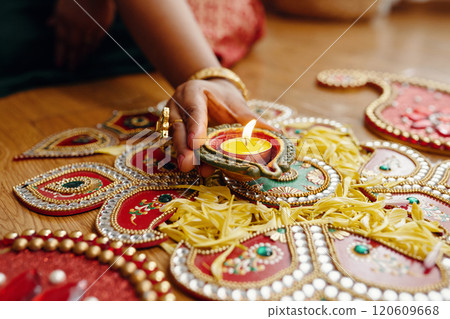 Celebrating Diwali with Traditional Oil Lamps and Rangoli 120609668