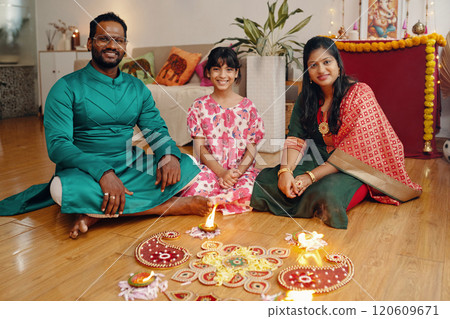 Celebrating Diwali with Family and Traditional Diyas 120609671