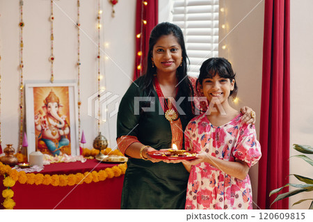 Celebrating Traditional Indian Festival at Home with Family Celebrating Traditional Indian Festival at Home with Family 120609815