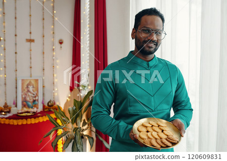 Holding Plate of Traditional Festival Sweets Smiling 120609831
