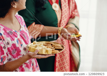 Sharing Indian Snacks During Cultural Gathering Sharing Indian Snacks During Cultural Gathering 120609923