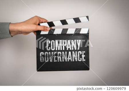 Company governance. Hand holding movie clapper 120609979