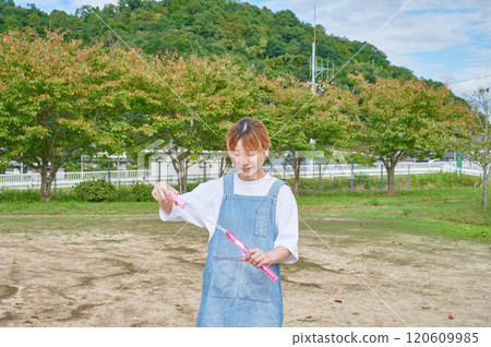 Nursery teachers playing in the park, countryside, soap bubbles 120609985