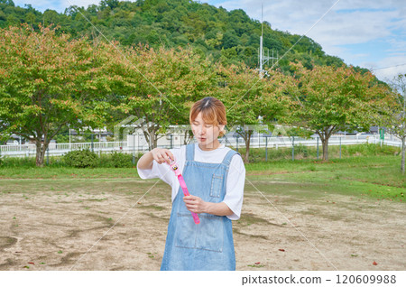 Nursery teachers playing in the park, countryside, soap bubbles 120609988