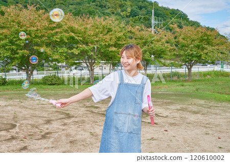 Nursery teachers playing in the park, countryside, soap bubbles Nursery teachers playing in the park, countryside, soap bubbles 120610002