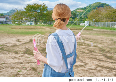 Nursery teachers playing in the park, countryside, soap bubbles Nursery teachers playing in the park, countryside, soap bubbles 120610171