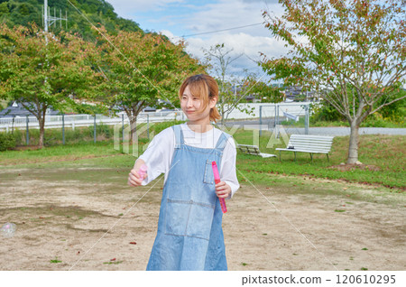 Nursery teachers playing in the park, countryside, soap bubbles Nursery teachers playing in the park, countryside, soap bubbles 120610295