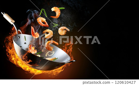 Shot of Wok Pan with Flying Ingredients witm shrimp, rice in the Air and Fire Flames Shot of Wok Pan with Flying Ingredients witm shrimp, rice in the Air and Fire Flames 120610427