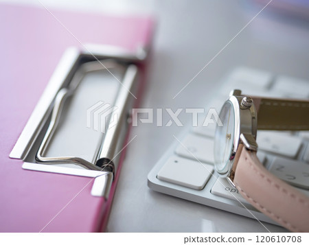 Binder, keyboard and watch on a table Binder, keyboard and watch on a table 120610708