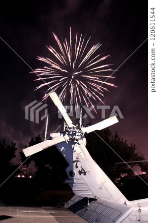 Beautiful fireworks burst into flames in the background of a US Navy helicopter tail 120611544