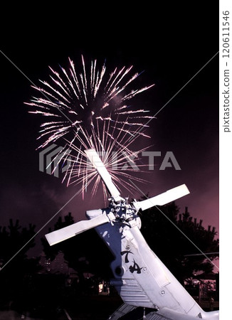 Beautiful fireworks burst into flames in the background of a US Navy helicopter tail 120611546