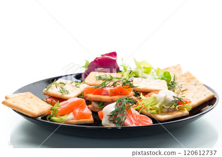 small snack canapes with crackers and lightly salted red fish Salmon, isolated on white background 120612737