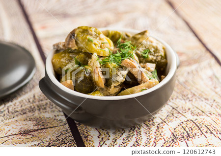 Brussel sprouts stewed in sour cream sauce with mushrooms and spices 120612743