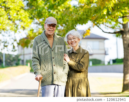 Senior couple: man with a cane and woman assisting him 120612941