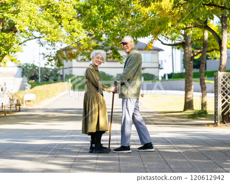 Senior couple: man with a cane and woman assisting him 120612942