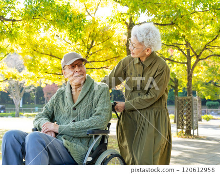 Senior couple: man in wheelchair and woman assisting him 120612958