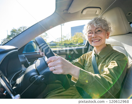 Smiling senior woman driving a car Smiling senior woman driving a car 120612968