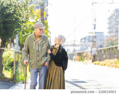 Senior couple walking together in the city Senior couple walking together in the city 120613001