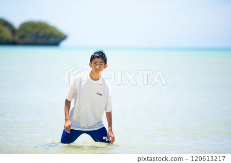 A boy standing in the sea after club activities A boy standing in the sea after club activities 120613217